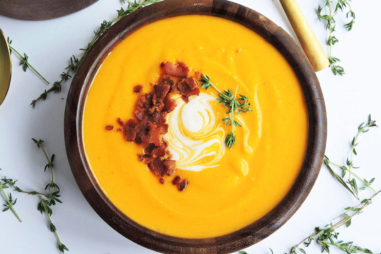 A bowl of Brown Butter Bacon Butternut Squash Soup shot from above