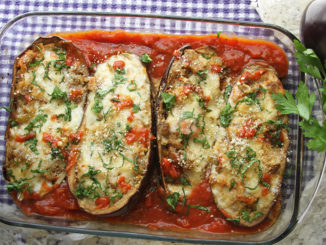 Eggplant Parmesan Bake in a casserole dish on a checkered dish towel
