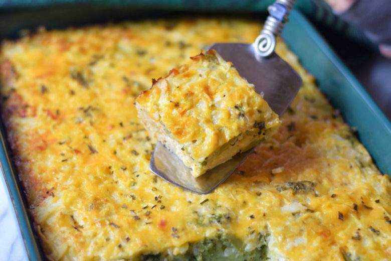 Hash Brown Casserole with Veggies in pan and on spatula, ready to be served