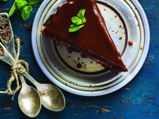 Piece of chocolate cake with mint leaves