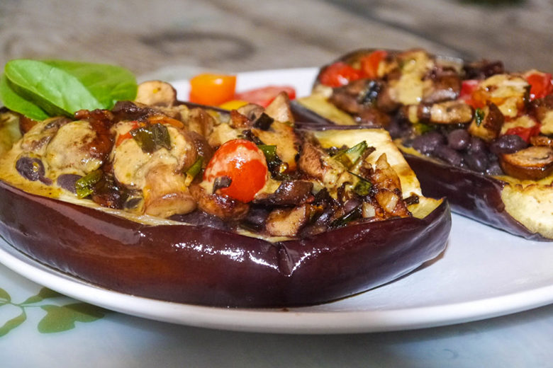Vegetarian Stuffed Eggplant with Savory Pistachio Cream on a white plate on countertop