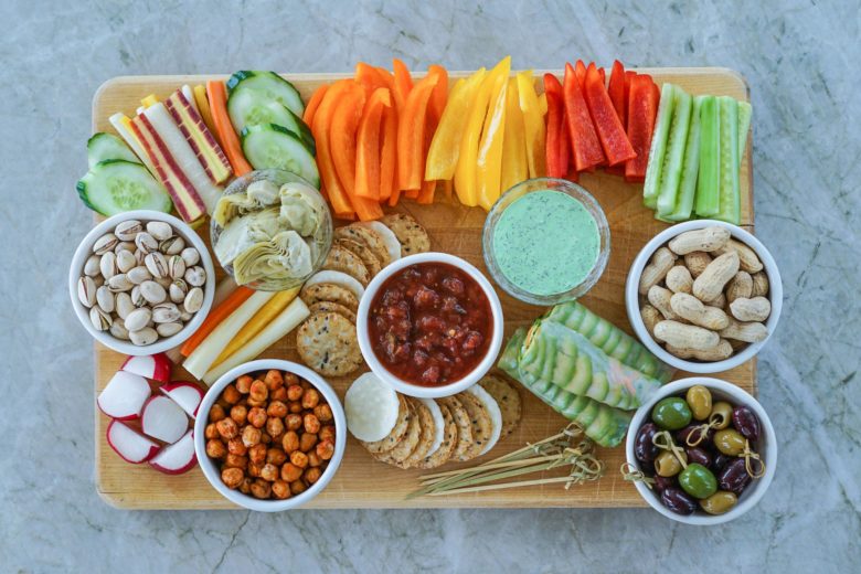 An assortment of healthy snacking options: fresh cut vegetables, nuts, whole grain crackers, etc.