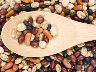 A Variety Of Dried Beans And Wooden Spoon
